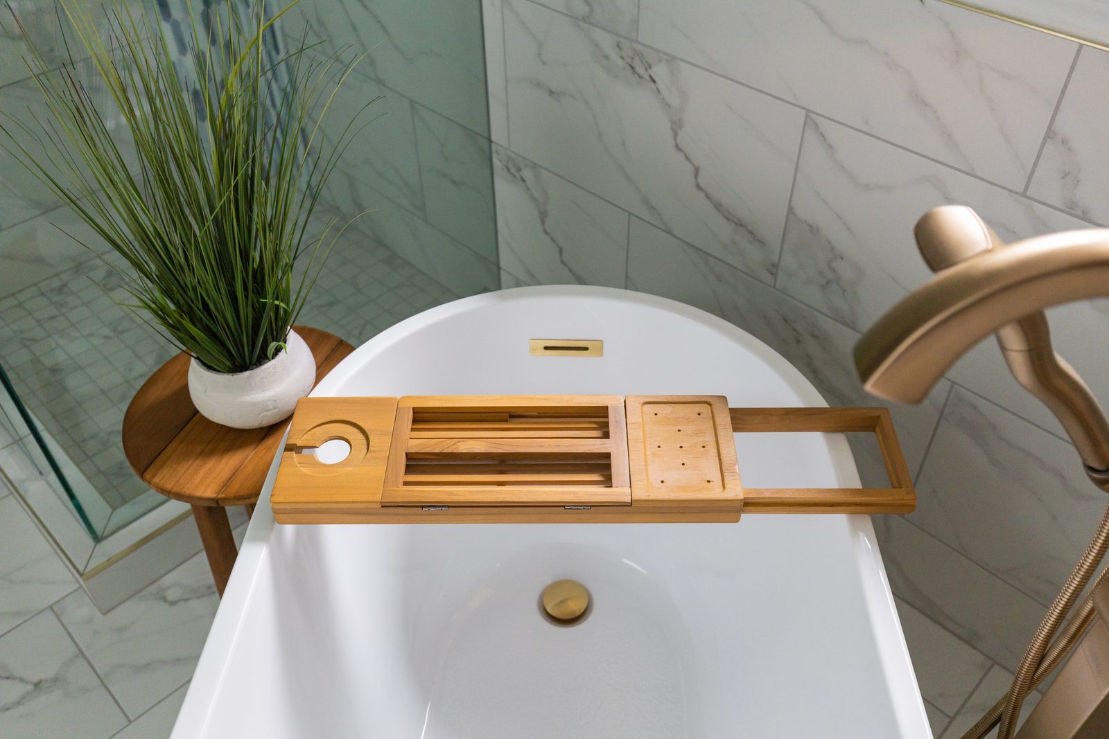Spa-style soaking tub detail with brass fixtures in a Stay Flourish-managed short-term rental bathroom