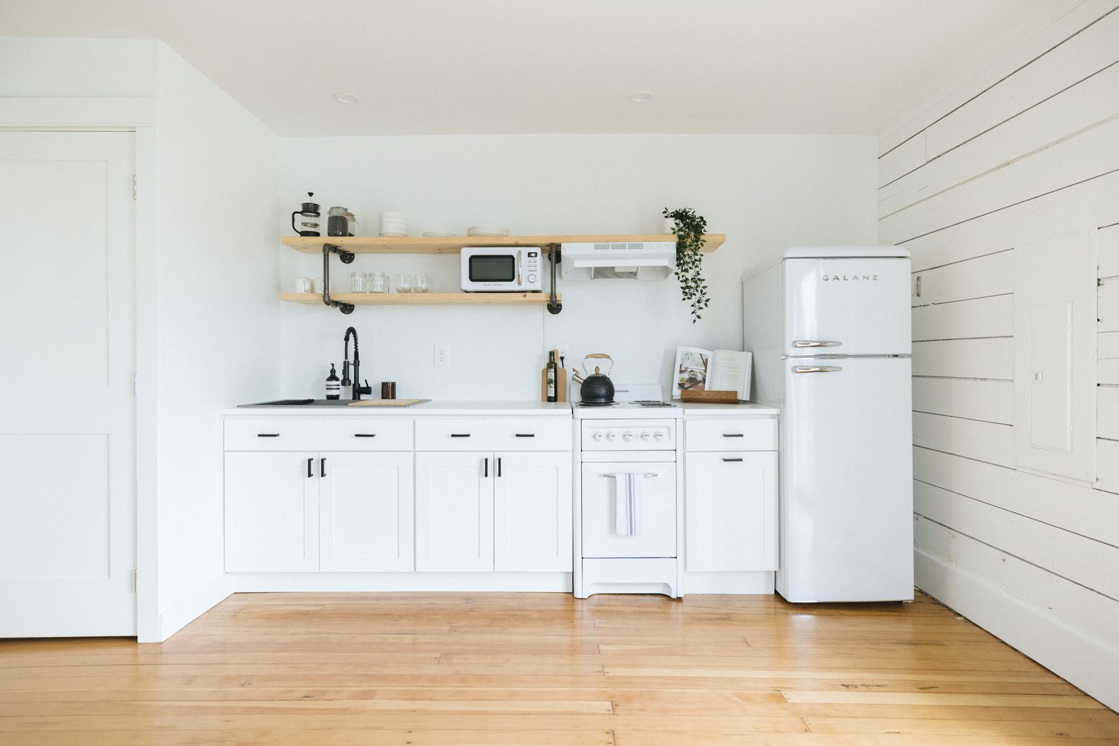 Bright white minimalist kitchen inside a Stay Flourish-managed short-term rental